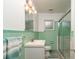 Bathroom featuring a glass shower and decorative mint green tiling at 727 Se 12Th St, Ocala, FL 34471