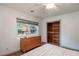 Bright bedroom with hardwood floors, a dresser, and a closet with wooden shelving at 727 Se 12Th St, Ocala, FL 34471