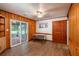 Dining room with wood paneled walls and access to screened in porch through sliding glass doors at 727 Se 12Th St, Ocala, FL 34471