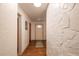 Inviting hallway with hardwood floors, a decorative stone accent wall, and a bright front door at 727 Se 12Th St, Ocala, FL 34471