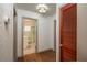 Hallway view showcasing the bathroom with a glass-enclosed shower and storage closet at 727 Se 12Th St, Ocala, FL 34471