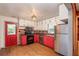 This eat-in kitchen features stainless steel appliances and red and white cabinets at 727 Se 12Th St, Ocala, FL 34471