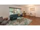 Inviting living room features a plush sofa, stylish rug, and ample natural light from a large window at 727 Se 12Th St, Ocala, FL 34471