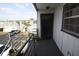 Entrance view to condo shows exterior and parking lot with painted door, balcony, and landscaping at 1000 S Semoran Blvd # 306, Winter Park, FL 32792