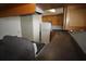 Angle kitchen shot with wood cabinets, white appliances, and countertops at 1000 S Semoran Blvd # 306, Winter Park, FL 32792