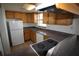 Kitchen with wood cabinets, white appliances, and countertops at 1000 S Semoran Blvd # 306, Winter Park, FL 32792