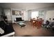 Open-concept living room featuring dining area, neutral paint, and modern furnishings at 1000 S Semoran Blvd # 404, Winter Park, FL 32792