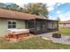 Backyard with a hot tub and screened in porch at 10441 Sw 54Th Ct, Ocala, FL 34476