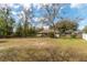 Spacious fenced backyard with mature trees, providing ample space and privacy at 10441 Sw 54Th Ct, Ocala, FL 34476