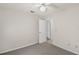 Neutral bedroom featuring carpet, ceiling fan and an adjoining doorway at 10441 Sw 54Th Ct, Ocala, FL 34476