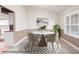 A dining area featuring tile flooring, wainscoting, a table set for four, and a window with plantation shutters at 10441 Sw 54Th Ct, Ocala, FL 34476