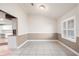 A dining area featuring tile flooring, wainscoting, and a window with plantation shutters at 10441 Sw 54Th Ct, Ocala, FL 34476