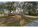 Inviting one-story home nestled among mature trees, with a long driveway and well-kept front yard at 10441 Sw 54Th Ct, Ocala, FL 34476