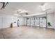 Large garage with a car lift, tools, and storage cabinets, offering space for vehicle maintenance and projects at 10441 Sw 54Th Ct, Ocala, FL 34476
