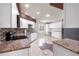 Spacious kitchen with white cabinetry, granite countertops, and stainless steel appliances for a sleek and modern feel at 10441 Sw 54Th Ct, Ocala, FL 34476