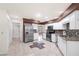 This kitchen boasts stainless steel appliances, granite countertops, mosaic backsplash, and white cabinetry at 10441 Sw 54Th Ct, Ocala, FL 34476