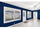 This living area features tiled floors, a ceiling fan, and white shuttered windows that enhance natural light at 10441 Sw 54Th Ct, Ocala, FL 34476