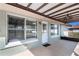 Charming patio with a pergola, windows, and a door, providing a cozy transition between indoor and outdoor living spaces at 10441 Sw 54Th Ct, Ocala, FL 34476
