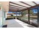 Screened patio offers an airy, shaded area with views of the landscaped backyard and a pergola, ideal for relaxation and entertaining at 10441 Sw 54Th Ct, Ocala, FL 34476