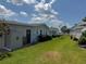 Spacious backyard showcasing lush green lawn, storage shed, and the home's light-colored siding at 106 Pyracantha Ln, Leesburg, FL 34748