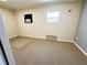 Bedroom featuring neutral carpeting, an AC unit, and natural light from two windows at 106 Pyracantha Ln, Leesburg, FL 34748