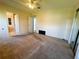 Roomy bedroom with carpet, closet and white ceiling fan fixture, and two entryways, with a side window at 106 Pyracantha Ln, Leesburg, FL 34748