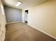 Bedroom featuring neutral carpeting, a two toned paint scheme and natural light at 106 Pyracantha Ln, Leesburg, FL 34748