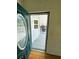 Front door boasts an oval window providing a glimpse to the inviting exterior deck at 106 Pyracantha Ln, Leesburg, FL 34748
