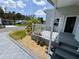 Lovely front porch with gray decking, white railings, and manicured landscaping at 106 Pyracantha Ln, Leesburg, FL 34748