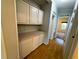 Hallway features wood floors and built-in cabinets for extra storage at 106 Pyracantha Ln, Leesburg, FL 34748