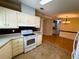 Well-lit kitchen with white appliances and ample storage at 106 Pyracantha Ln, Leesburg, FL 34748