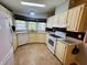 Well-lit kitchen with white appliances and ample storage at 106 Pyracantha Ln, Leesburg, FL 34748