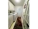 Bright laundry room with a modern washer and dryer, and convenient storage space at 106 Pyracantha Ln, Leesburg, FL 34748