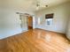 Open-concept living room boasts sleek wood floors, sliding glass doors, and plentiful natural light at 106 Pyracantha Ln, Leesburg, FL 34748