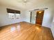 Spacious living room with wood flooring, ceiling fan, and sliding door access at 106 Pyracantha Ln, Leesburg, FL 34748