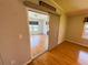 Inviting living room with sliding glass door and warm wood flooring creates a comfortable space at 106 Pyracantha Ln, Leesburg, FL 34748