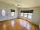 Bright living room featuring a ceiling fan, natural light, and elegant window treatments at 106 Pyracantha Ln, Leesburg, FL 34748