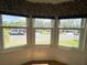 Bright living room with three-pane windows offering neighborhood views and lots of natural light at 106 Pyracantha Ln, Leesburg, FL 34748