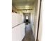 Mud room with utility door, includes full sized refrigerator and access to an exterior door at 106 Pyracantha Ln, Leesburg, FL 34748
