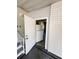 Mud room with a refrigerator leading to the outside, featuring gray floors and neutral walls at 106 Pyracantha Ln, Leesburg, FL 34748