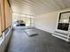 Enclosed patio featuring large sliding windows, patterned tile flooring, and a neutral color scheme at 106 Pyracantha Ln, Leesburg, FL 34748