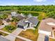 Aerial view of a well-maintained home with a pond view and manicured lawn at 11172 Pinewood Cove Ln, Orlando, FL 32817