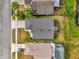 Aerial view of a single-Gathering home with mature trees, a green lawn and a pond nearby at 11172 Pinewood Cove Ln, Orlando, FL 32817