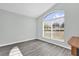 Bright bedroom features a large window offering abundant natural light and stylish flooring at 11172 Pinewood Cove Ln, Orlando, FL 32817