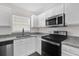 Well-equipped kitchen with granite countertops, stainless steel appliances, and modern finishes at 11172 Pinewood Cove Ln, Orlando, FL 32817