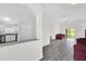 Bright living room showcasing gray floors and an open layout adjacent to the kitchen at 11172 Pinewood Cove Ln, Orlando, FL 32817