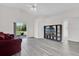 Spacious living room with gray floors, sliding glass doors, and a ceiling fan at 11172 Pinewood Cove Ln, Orlando, FL 32817