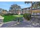 Multi-story residential building, green lawn, mature trees, and outdoor table, creating a communal and inviting atmosphere at 125 Water Front Way # 200, Altamonte Springs, FL 32701