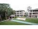 Residential building exterior featuring multi-story units, a central lawn, and mature trees creating a welcoming atmosphere at 125 Water Front Way # 200, Altamonte Springs, FL 32701