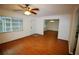 Open living area with wood floors, ceiling fan, and natural light from a large window at 125 Water Front Way # 200, Altamonte Springs, FL 32701